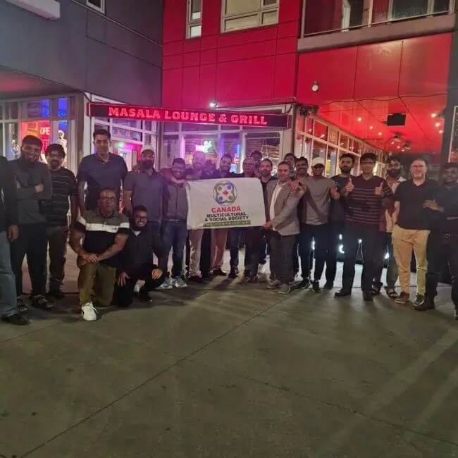 group cheering outside the famous indian restaurant masala lounge and grill calgary