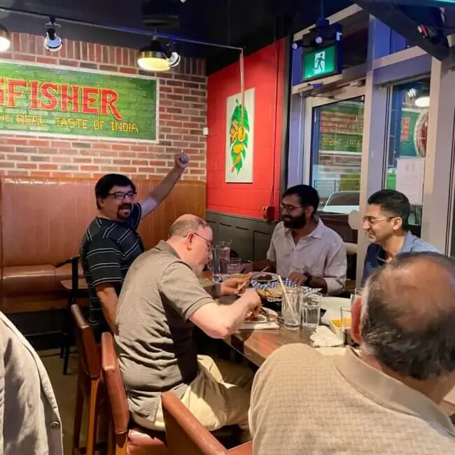 guys enjoying delicious indian food at the best indian restaurant in downtown calgary